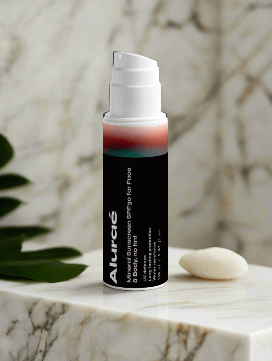 Aluraé Mineral Sunscreen SPF30 bottle on marble surface, showcasing sleek design and effective sun protection.